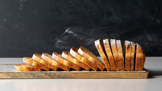 Sliced loaf of sourdough bread on a cutting board