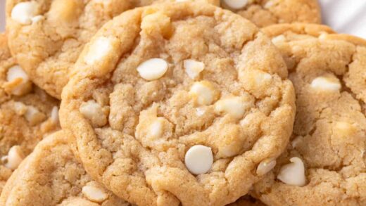 close up of white chocolate macadamia nut cookies on a plate.