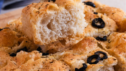 Focaccia Bread piece - airy light interior with crusty top and sliced olives