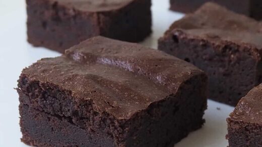 Slices of Thermomix Brownies on a white bench.