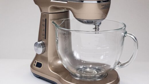 The Champage colored  Breville Bakery Chef Mixer with a glass mixing bow.