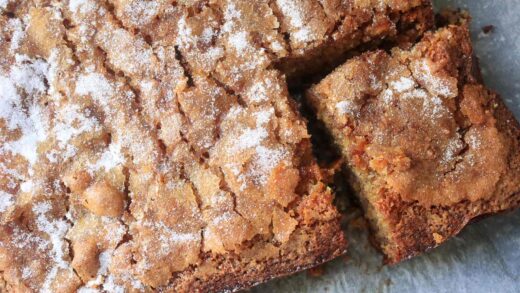 Banana crunch cake with a corner slice cut out.