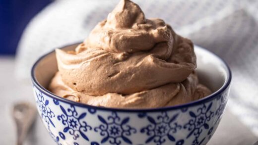 Chocolate whipped cream piled into a blue and white bowl.