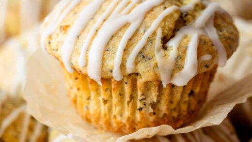 close-up of lemon poppy seed muffin with icing on top.