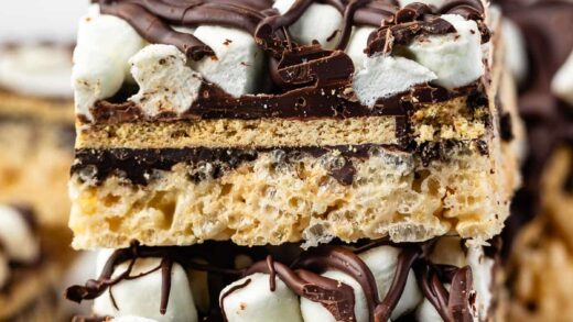 stacked Rice Krispie treats with marshmallows and chocolate on top.