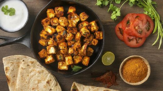 Recipe spread for Spicy Paneer Tikka Wrap with ingredients on a wooden table.