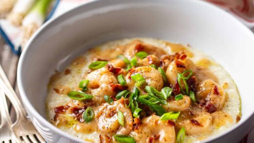 Shrimp and grits in a wide ceramic bowl.