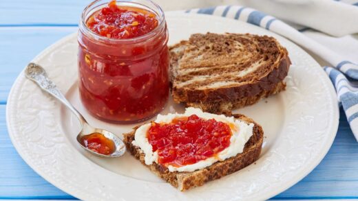 Tomato Chilli Chutney is in a jar and served with toast.