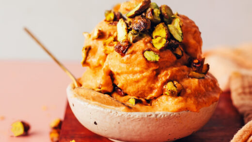 Bowl with scoops of vegan apricot sorbet topped with candied pistachios