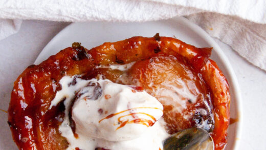 overhead apple tartlet topped with ice cream and caramel