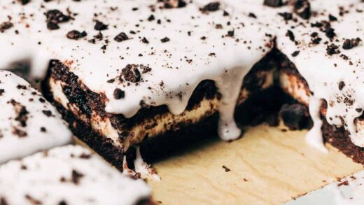 close up on sliced cookies and cream pop tart bars with one bar removed from pan