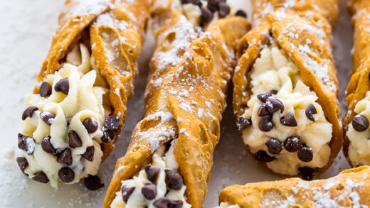 Cannoli with chocolate chips on a white plate.