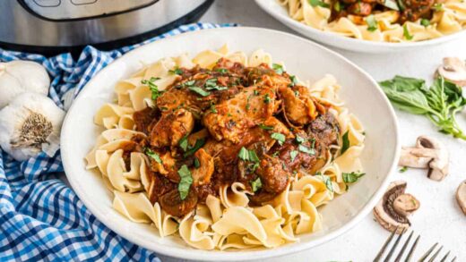 Egg noodles topped with chicken cacciatore.