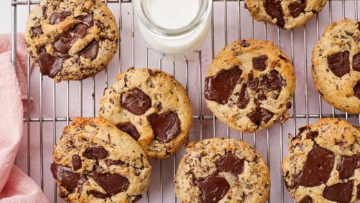 A top down view of Cream Cheese Chocolate Chip Cookies served on a cooling rack with milk.