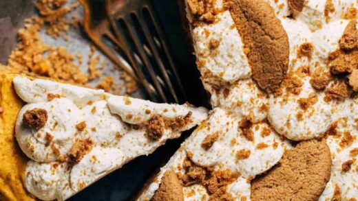 the top of a no bake pumpkin pie with whipped cream and gingersnap cookies