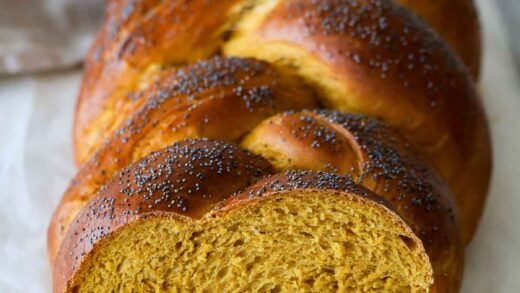 A pumpkin challah loaf showing its crumb.