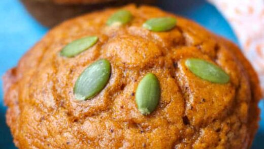 A Dairy-Free Pumpkin Muffin topped with pepitas.